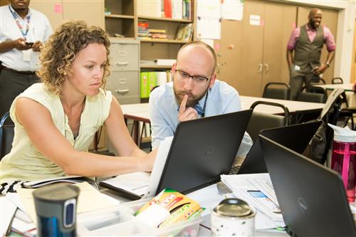 Teachers collaborating at a work space 